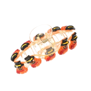 Detail of orange hair claw clip with miniature pumpkins wearing black wizard hats and scarves