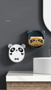 Detail of wall-mounted panda soap holders in black-white and yellow-blue color options