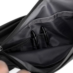 Detailed view of the internal storage compartment featuring two functional pen slots
