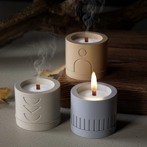 Three-piece cylindrical aromatherapy candles with geometric relief and wood wicks