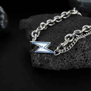 Silver lightning necklace with blue enamel and zircon on black volcanic rock