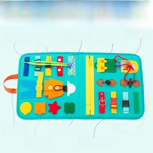 Detail of teal sensory busy board showing 21 learning activities and buckle types