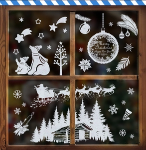 Détail de stickers de Noël statiques blancs avec Père Noël et flocons sur une fenêtre