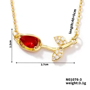 Detailed view of tulip necklace with red pear-shaped zircon and white stones