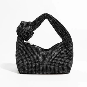 Detailed close-up of a black rhinestone hobo bag featuring a unique knotted handle design