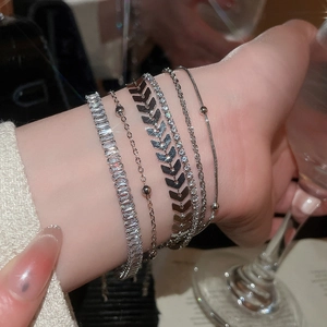 Detail shot of five-piece silver bracelet set with zircon stones on model's wrist