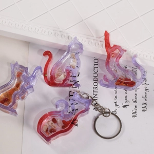 Detailed macro view of gradient resin cat charm with stone inlay and gold glitters