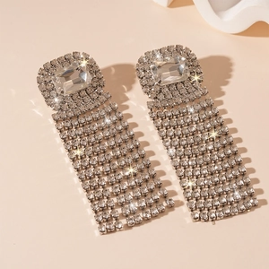 Detail of silver long tassel earrings featuring rectangle rhinestone and fringe