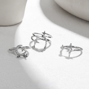 Detailed macro view of three silver star and moon rings with sparkling crystals