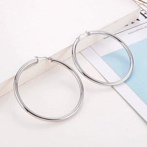 Polished silver stainless steel large hoop earrings on a clean white background