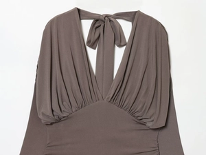 Close-up of the V-neckline and ruched texture on a brown long-sleeved mini dress