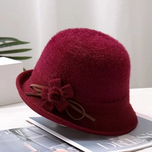 Detail of wine red faux mink fur cloche hat with fabric flower and ribbon accents