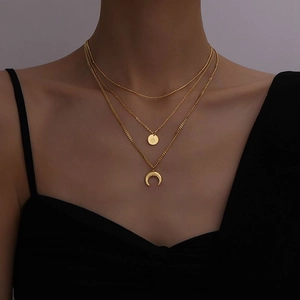 Retro triple-layered gold necklace featuring celestial starburst and crescent moon pendants