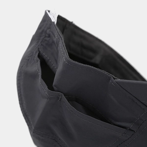 Macro view of black outdoor baseball cap fabric with parallel reinforced stitching lines