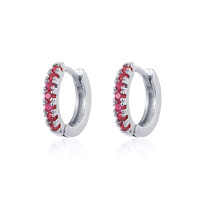 Detail view of silver earrings with sparkling red round zircons and mirror reflection