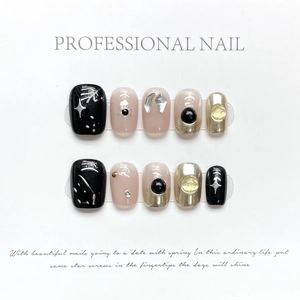 Handmade press-on nail kit featuring black sun heart design and metallic gothic patterns