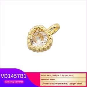 Macro shot of 18K gold plated brass charm with cubic zirconia heart and star detailing