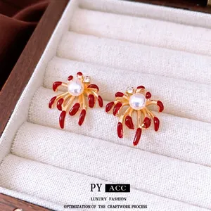 Exquisite gold-plated fireworks earrings with white pearl and red enamel petal accents