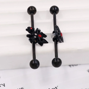 Detail of gothic industrial barbell with black spider and red zircon stones