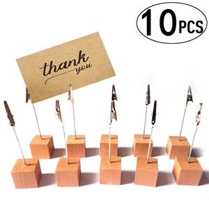 Close-up of 10-piece wooden card holder set with metal alligator clips for photos