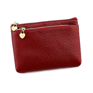 Detail of red genuine leather coin purse with heart zipper and lychee texture