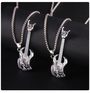 Detailed close-up of silver guitar and rock hand skull pendants on stainless steel chains
