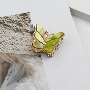 Detail of vintage double-layered enamel butterfly hair clip in green marble and gold finish