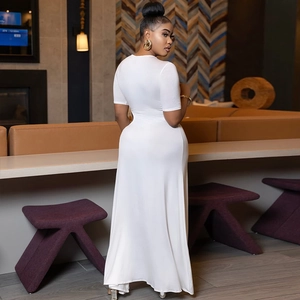 Detail of white round-neck maxi dress featuring elegant ruched texture and slit design