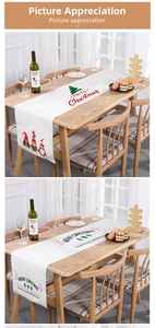 Close-up of Christmas table runner with festive gnomes and Merry Christmas print