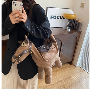 Detailed close-up of brown donkey plush shoulder bag with harness and rivet accents