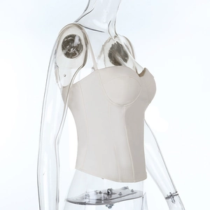 Side view of structured cream corset top with slim straps on transparent mannequin