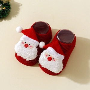Detail of red baby Christmas floor socks with 3D Santa Claus plush and anti-slip grip bottom