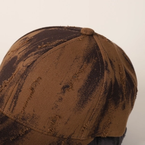 Close-up of distressed vintage baseball cap showing fabric texture and ripped details