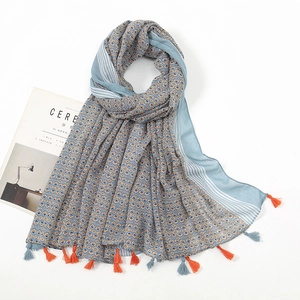Lightweight blue and orange geometric scarf with fringe tassels and soft cotton texture