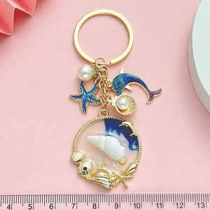 Ocean themed keychain with starfish, dolphin, shell charms and a measuring ruler scale