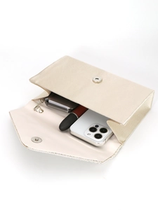 Open view of beige satin evening bag showing interior space for phone and makeup