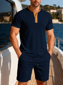 Detail of dark blue waffle knit texture and contrasting tan collar on summer polo set