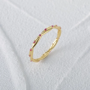 Detailed close-up of S925 sterling silver twisted gold ring with pink zircons