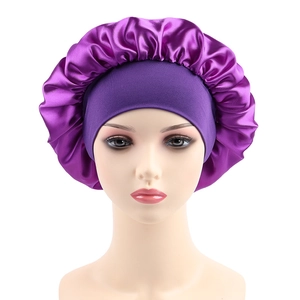 Deep purple satin sleep bonnet with wide elastic band on a mannequin head