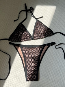 Sexy black lace cutout bikini set with halter neck and side tie bottoms on white background