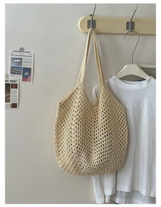 Close-up of cream handmade crochet tote bag featuring hollow diamond mesh weave detail
