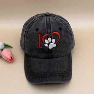 Close-up of vintage washed grey cotton baseball cap with embroidered heart paw logo