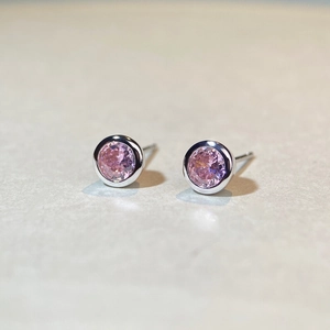 Macro shot of S925 sterling silver stud earrings with pink faceted round cut zircon stones