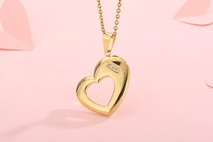 Macro view of golden heart-shaped necklace with three embedded sparkling rhinestones