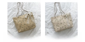 Detail of straw tote bags with floral embroidery and lace bows in khaki and off-white