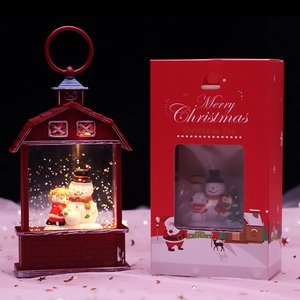 Red Christmas Santa snow globe lantern with figurines and festive holiday packaging box