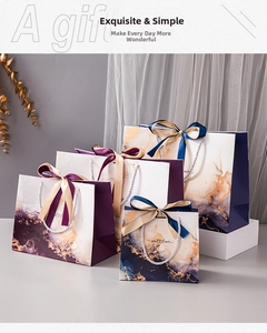 Detailed view of luxury marble gift bags with gold accents and elegant ribbon handles