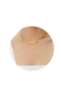 Detail of 18k gold plated stainless steel flat snake chain necklace on model