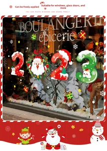 Close-up of double-sided Christmas window stickers with Santa Claus and festive patterns