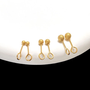 Macro shot of matte gold geometric stud earrings with C-shape screw back design